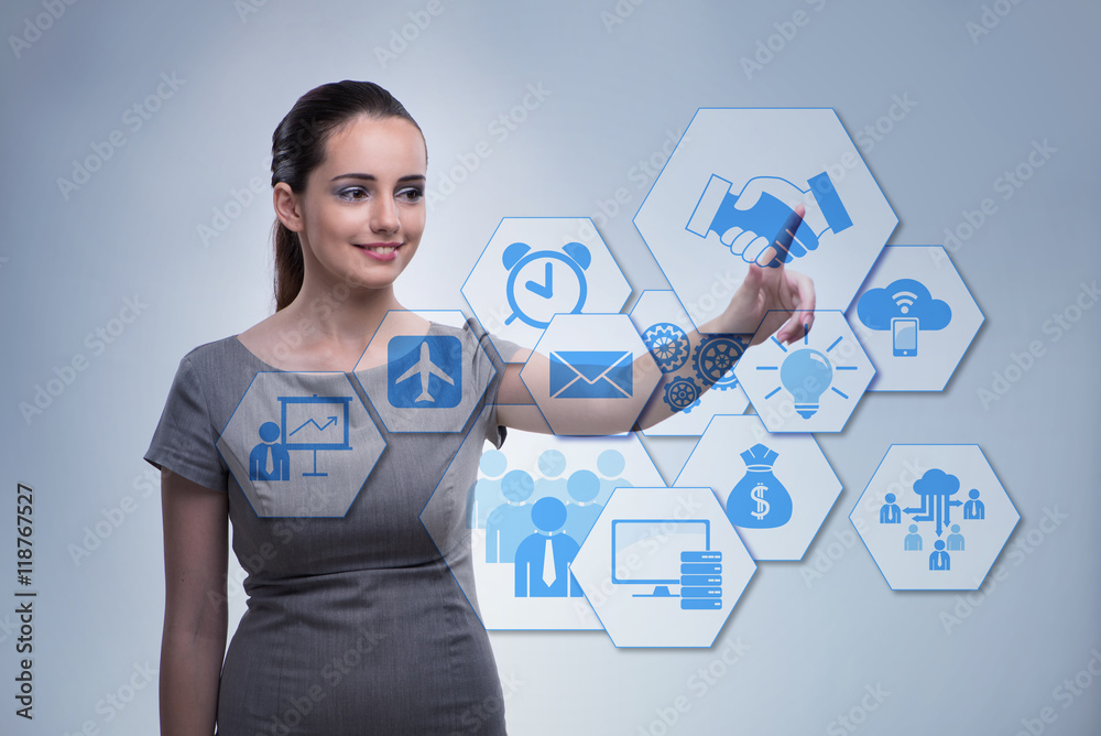 Wall mural woman pressing buttons in business concept