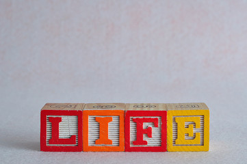 The word life spelled with colorful blocks