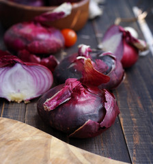 Red onions on a wooden table. Fresh  vegetables on wooden background table from above. Healthy, vegetarian, organic food  