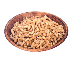 Organic italian rice pasta in wooden bowl