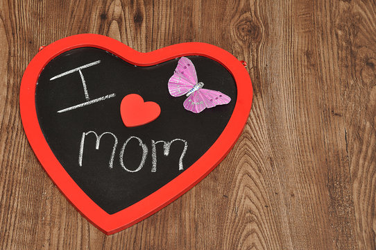 I love mom written on a blackboard decorate with a pink butterfl