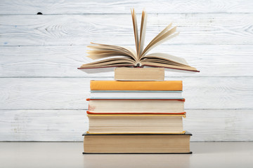 Open book, hardback books on wooden table. Education background. Back to school. Copy space for text.