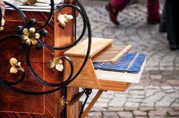 Detail of the hurdy-gurdy on street background