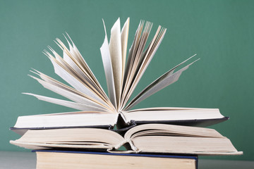 Fototapeta premium Open book, hardback books on wooden table. Education background. Back to school. Copy space for text.