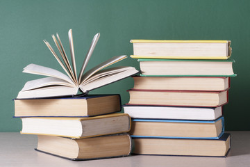 Open book, hardback books on wooden table. Education background. Back to school. Copy space for text.