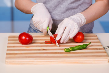 Hands of cook preparing salad