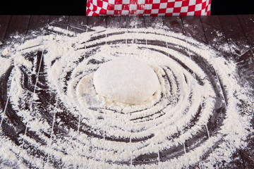 Cook preparing dough for baking in the kitchen