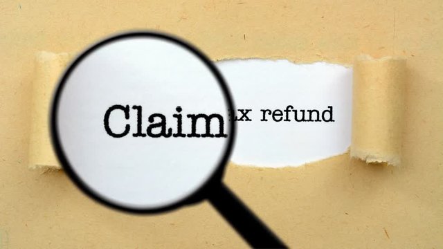 Magnifying glass on tax refund concept 