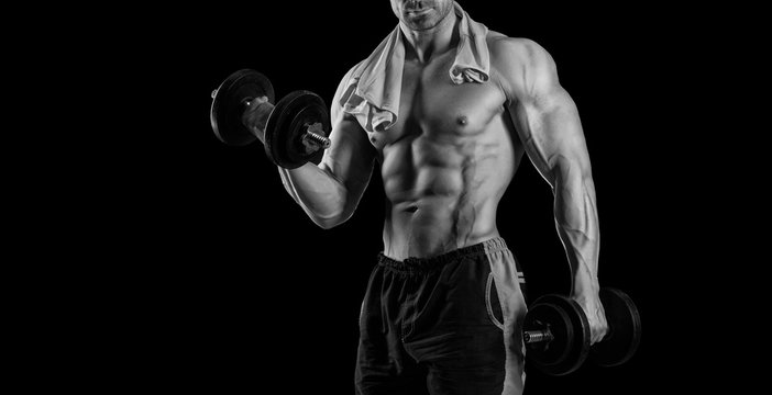 Closeup of a handsome power athletic man bodybuilder doing exerc