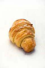 fresh, blueberry lavender croissant, isolated on white board, close up, vertical