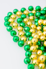 st. patricks day beads, close up and isolated on white background, vertical