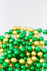 st. patricks day beads with copy space, close up and isolated on white background, vertical