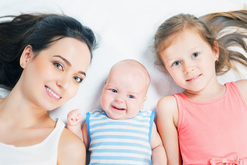 Happy mother with her children looking at camera