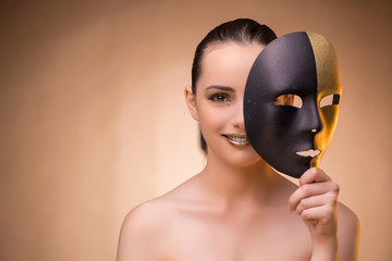 Young woman with mask in carnival concept