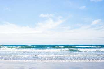 Fototapeta na wymiar beautiful, blue waves and open sky in Cannon Beach, Oregon