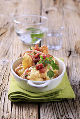 Potato dish on wooden background