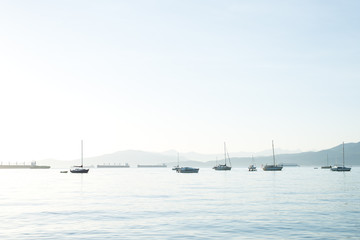 sailboats and freight ships resting on the ocean in Kitsilano, Vancouver, British Columbia, Canada