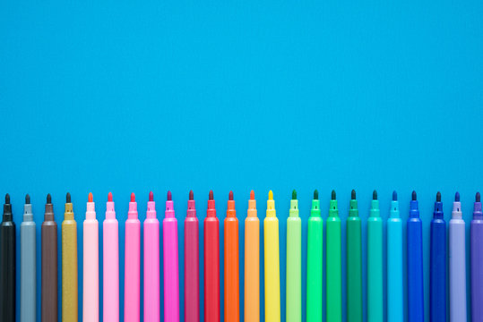 Colorful pen on blue background with copy space - Creative idea and education concept.