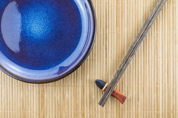 Flat lay handmade dish on Japanese mat background with sushi chopsticks