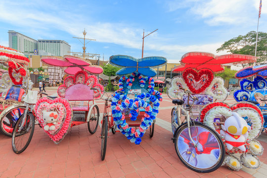 Fototapeta The decorated trishaw parking in a Famosa Castle in Malacca,tourists and local people can seen around the Famosa Castle in Malacca