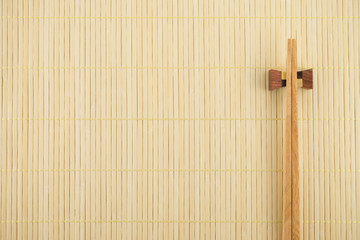 Flat lay of sushi chopsticks on Japanese bamboo mat