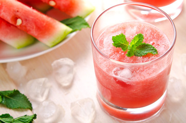Healthy watermelon smoothie with mint and ice in glass