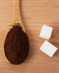 ground coffee in a wooden spoon on the table
