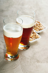 Glasses of beer and pistachio nuts