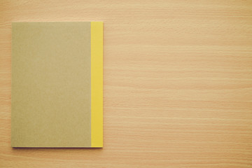 Blank notepad or notebook on wooden background - Business and education concept.