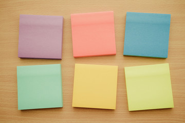 Color block of paper notes on wooden table