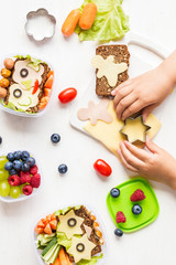 School lunch box for kids. Cooking. Child's hands. Top view, flat lay