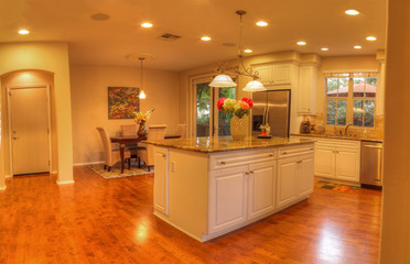 Irvine, CA, USA – August 19, 2016: Large kitchen with recessed lighting, wood floors, chrome...