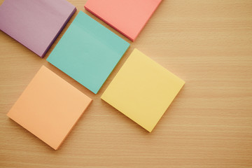 Color block of paper notes on wooden background