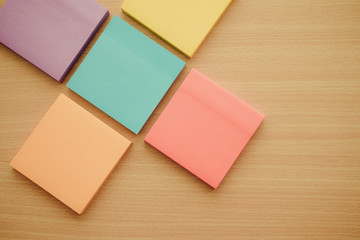 Color block of paper notes on wooden background