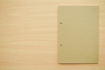 Naklejka premium Blank empty notepad on wooden table background - Business and education concept.