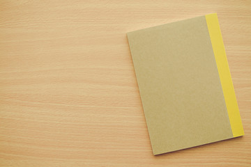 Blank empty notepad on wooden table background - Business and education concept.