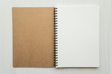 Blank empty notepad on white wooden table background - Business and education concept.