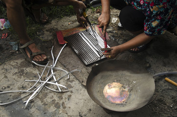 Thai people lead Ingots in pot local thai style for solder