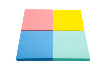 Four color block of paper notes isolated white background.