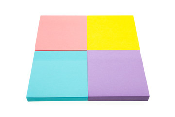 Four color block of paper notes isolated white background.