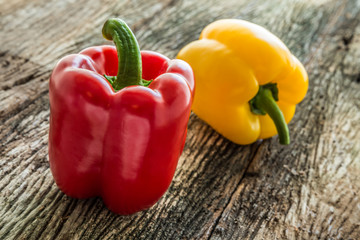 Sweet red and yellow pepper on old wooden