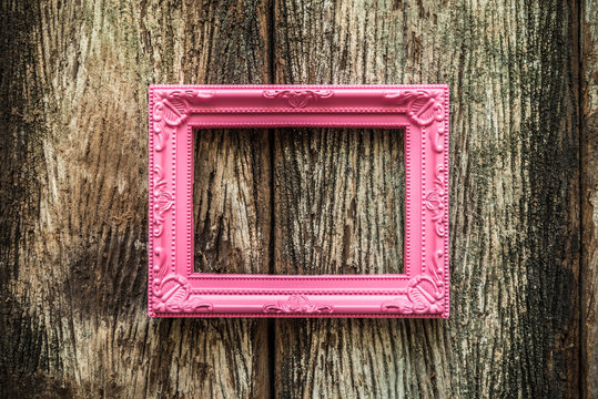 Vintage Pink Photo Frame On Old Wooden Background