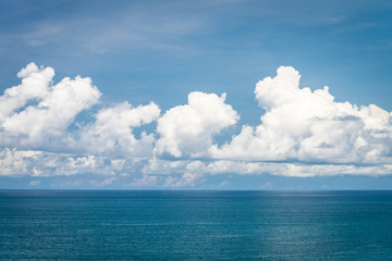 Beautiful blue ocean sea in sunny day clouds sky background - Travel summer vacation concept.