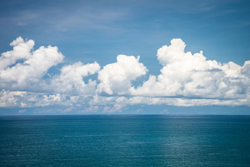 Naklejka na ściany i meble Beautiful blue ocean sea in sunny day clouds sky background - Travel summer vacation concept.