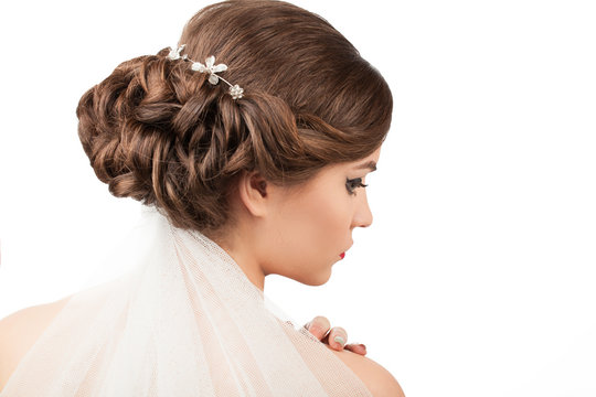 bride with wedding hairstyle and veil on a white background