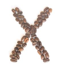 Letter X made of coffee beans under a daylight isolated on white background