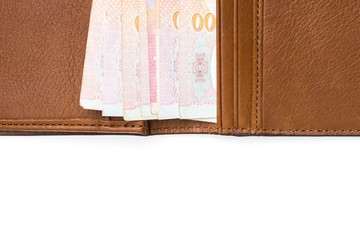 Thai cash in brown leather wallet isolated on white background
