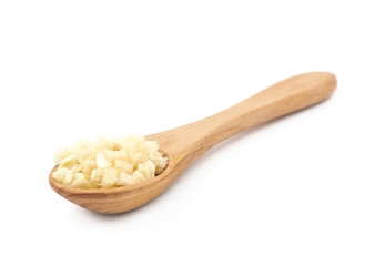 Spoon of minced garlic isolated