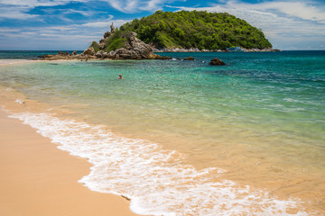 Beautiful tropical island beach in sunny day background. Summer holiday vacation in green nature outdoor concept.