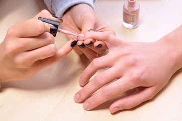 Obraz na płótnie Canvas Closeup shot of woman in a nail salon. Receiving a manicure by a beautician.